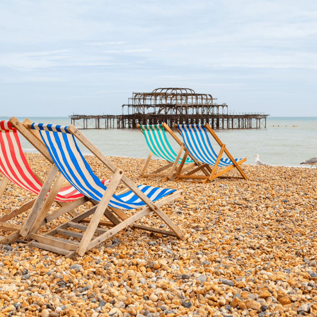 Brighton beach with two deck chairs and the west pier 