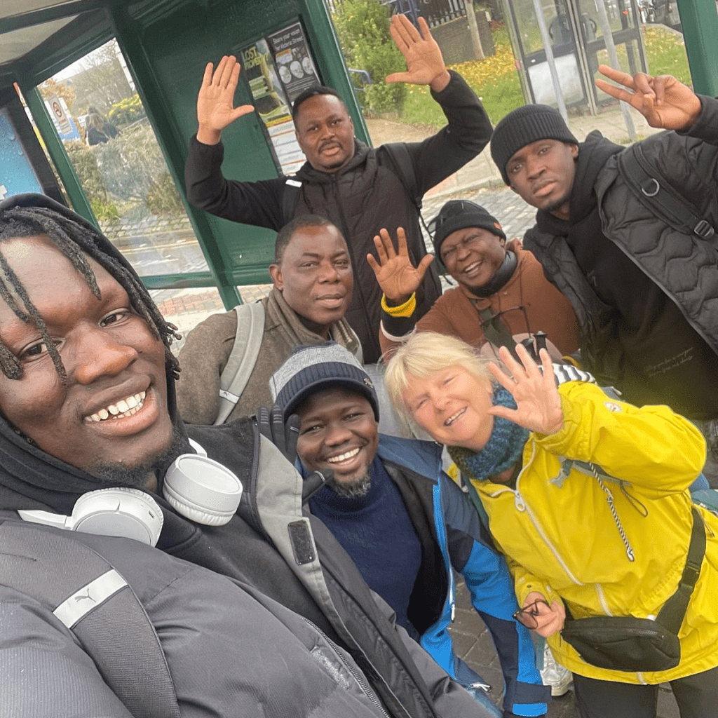 Group of people waving and smiling
