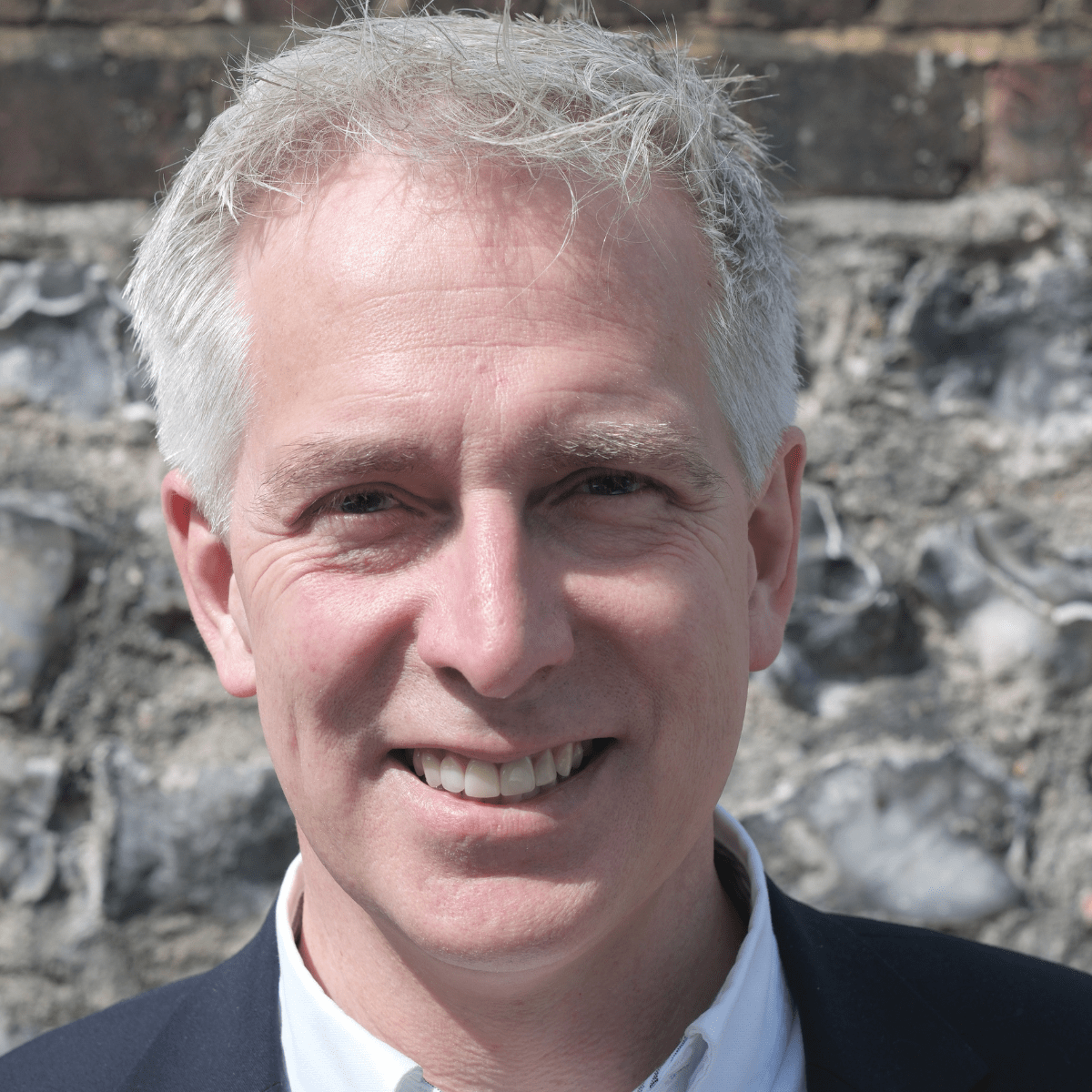 Headshot of Julian Caddy smiling to camera