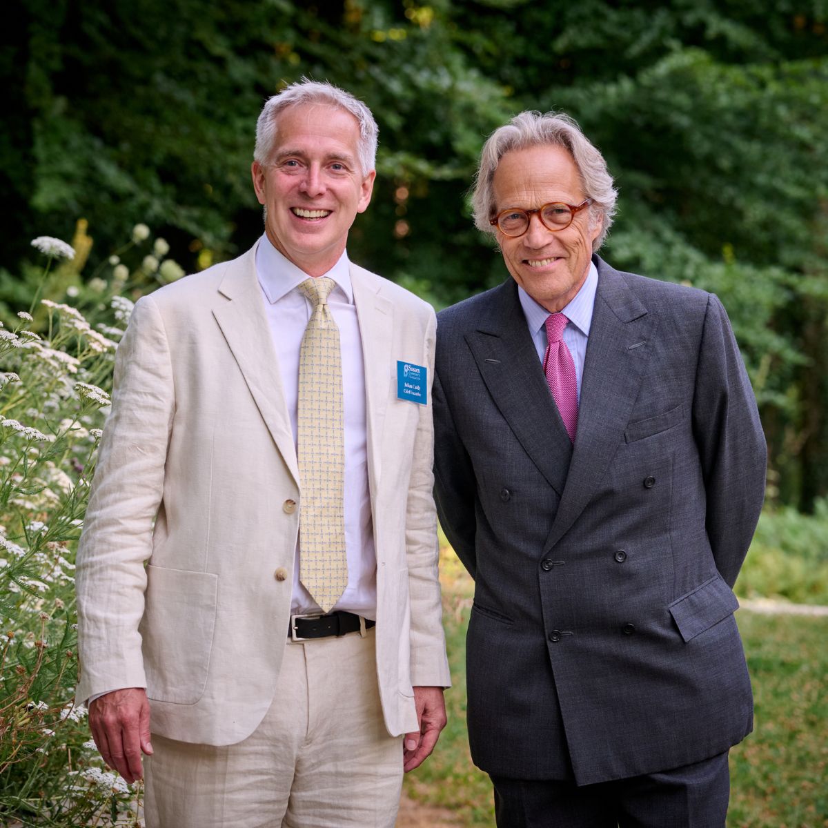 Julian Caddy and the 11th Duke of Richmond smiling in Goodwood Art Foundation lawns