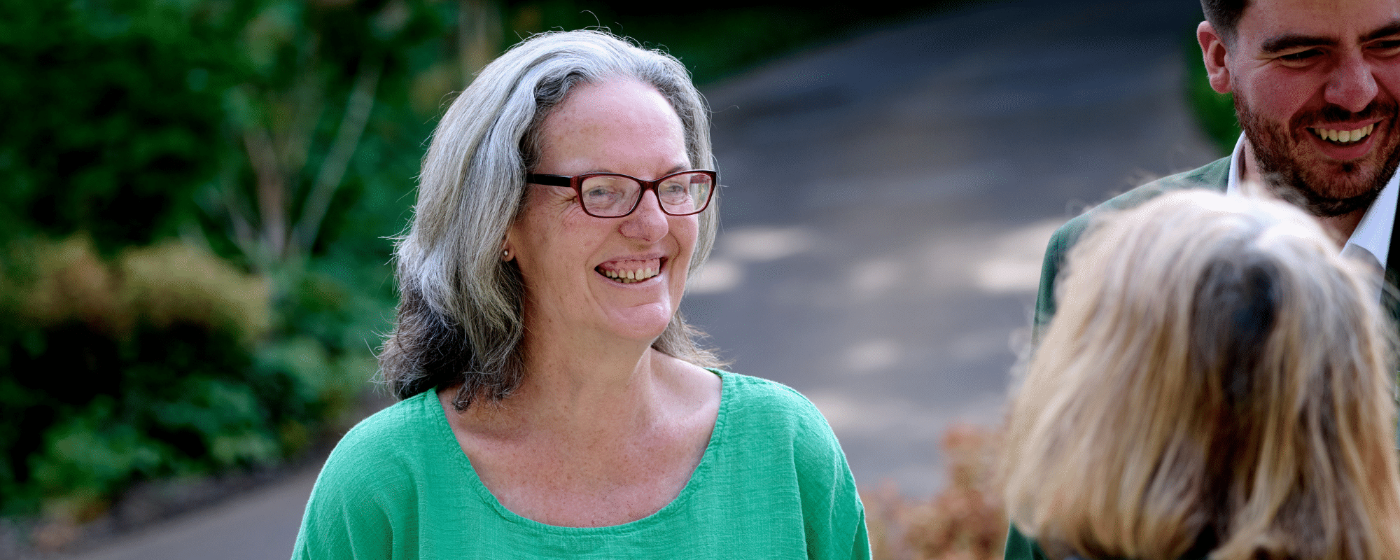 Tracey is smiling talking at an event